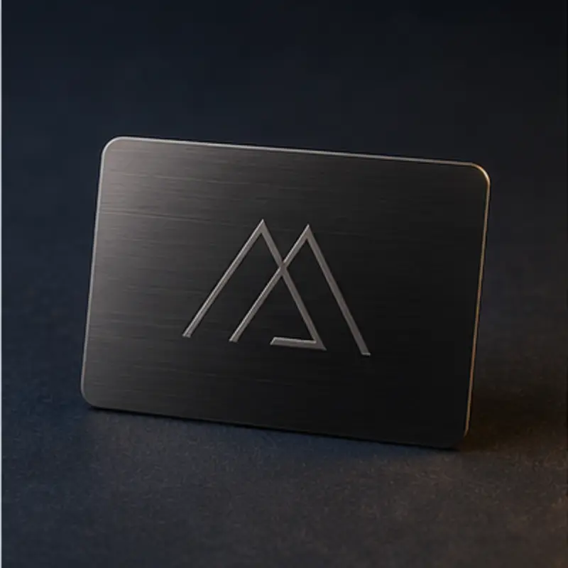 Black anodized aluminum business card with an engraved geometric mark