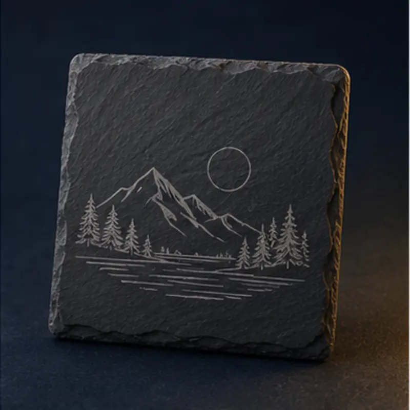 Dark slate coaster with an engraved mountain landscape
